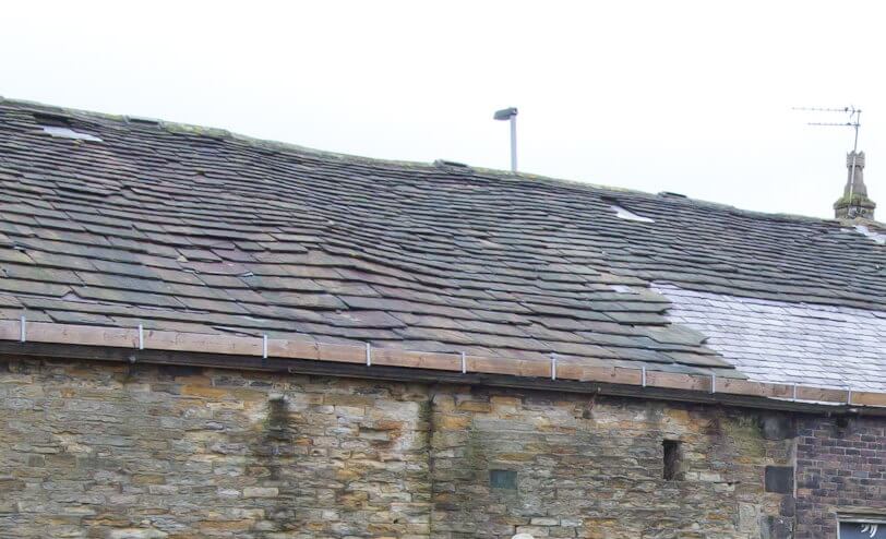 Bad roof on a house House with a bad roof